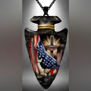 Arrowhead Pendent with an "Arm Holding an American Flag Infront of a Cross